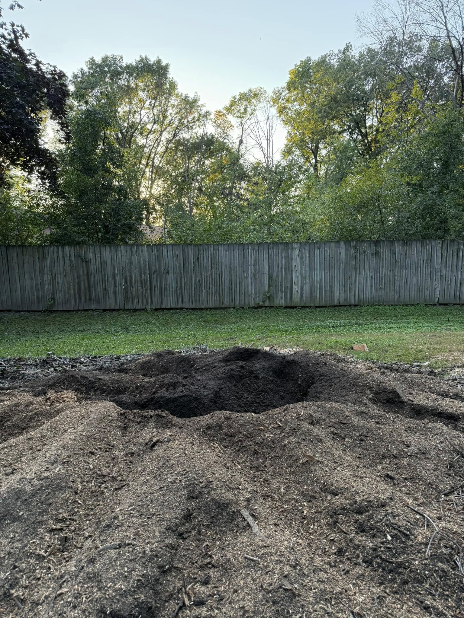 After stump grinding — stump fully ground and area cleared near fence, Timber Ridge